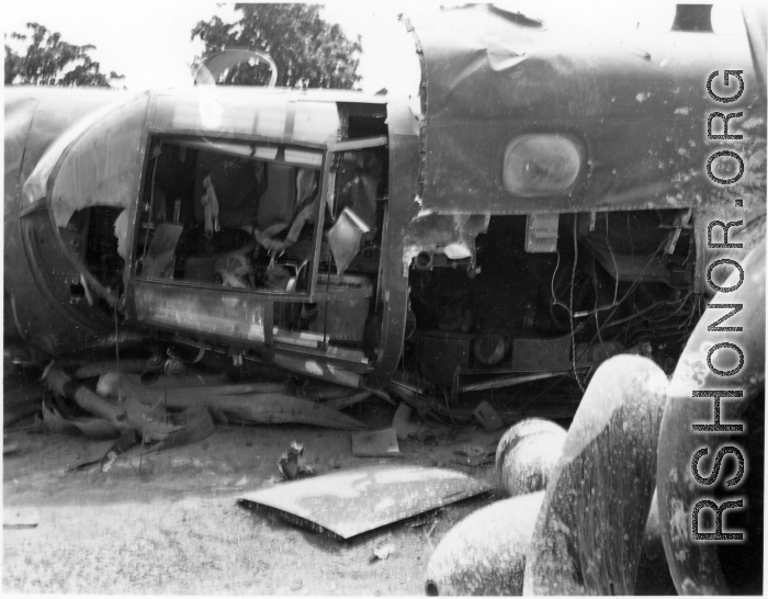 Wrecked B-25 Mitchell bomber on the ground in the CBI. The wreck was apparently at an air base, and probably on take-off, as the craft is sprayed with fire-retardant foam, and bombs are scattered about the wreck site. During WWII.