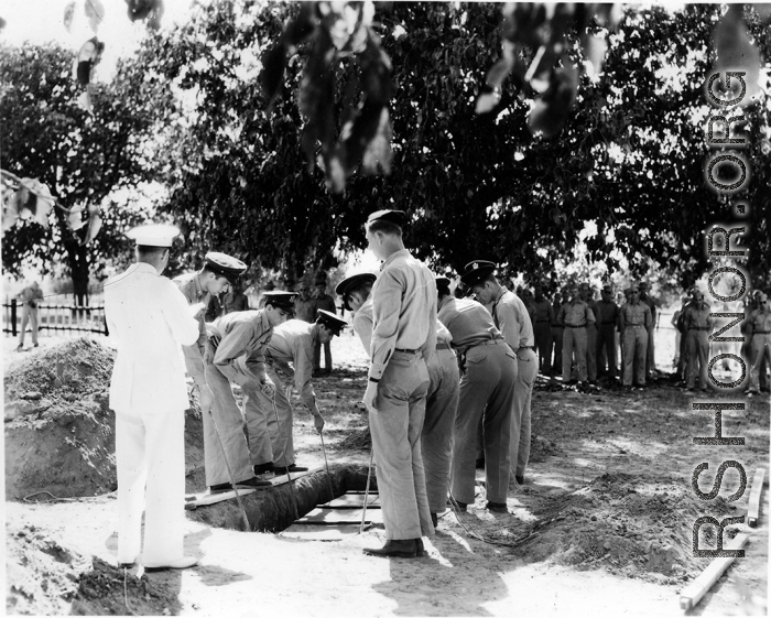 Solemn burial ceremony for American GIS who had died at a temporary war-time graveyard. In the CBI, during WWII.