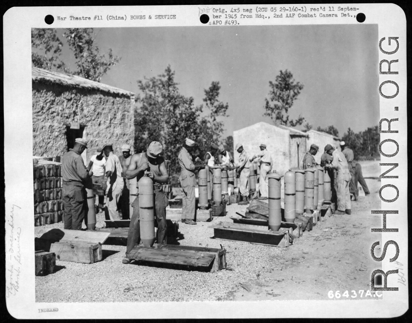 An exclusively African-American crew uncrate and prepare M47 A2 chemical incendiary bombs for use on on a 20th Bomber Command Boeing B-29 raid. China, during WWII.