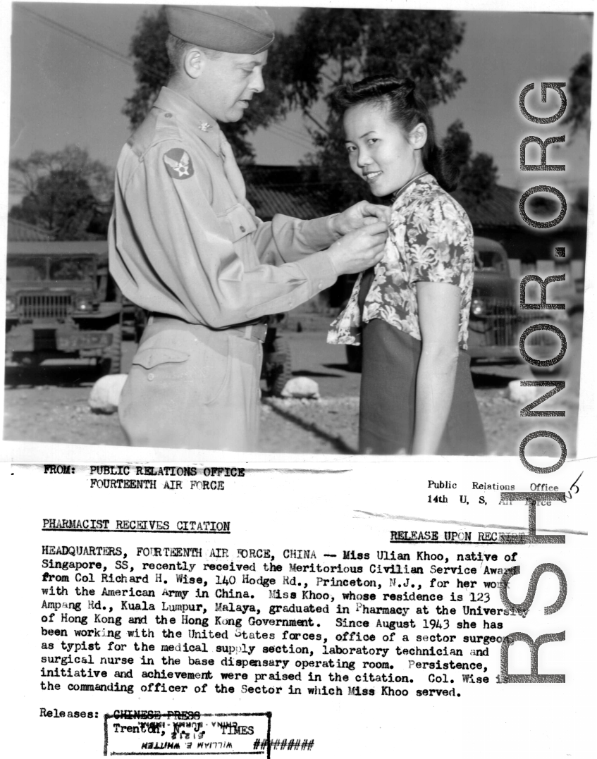 Miss Ulian Hhoo of Singapore receives the Meritorious Civilian Service Award from Col. Richard H. Wise for her work with the American Army in China. Since August 1943 she had worked in the office of a sector surgeon as typist for the medical supply section, laboratory technician, and surgical nurse in the base dispensary operating room.