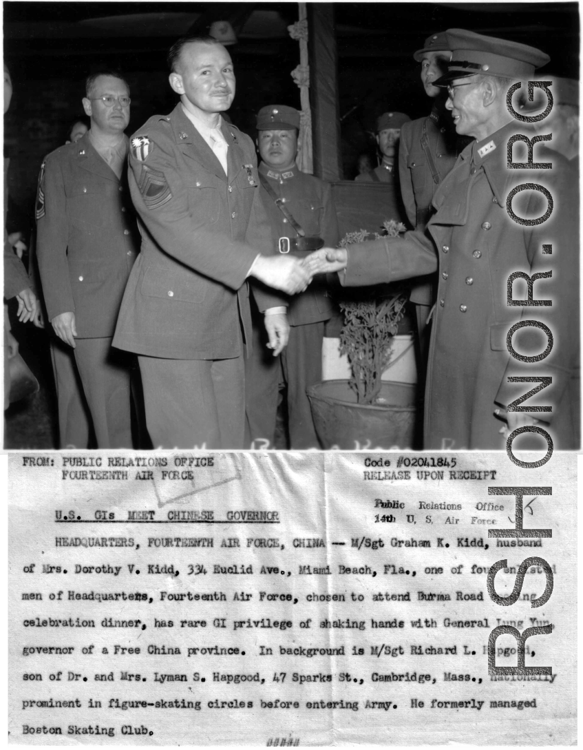 Graham K. Kidd was one of four enlisted men of Headquarters of the 14th Air Force chosen to attend Burma Road opening celebration dinner, and shaking hands with General Lung Yun. The American soldier behind them is M/Sgt. Richard L. Hapgood.