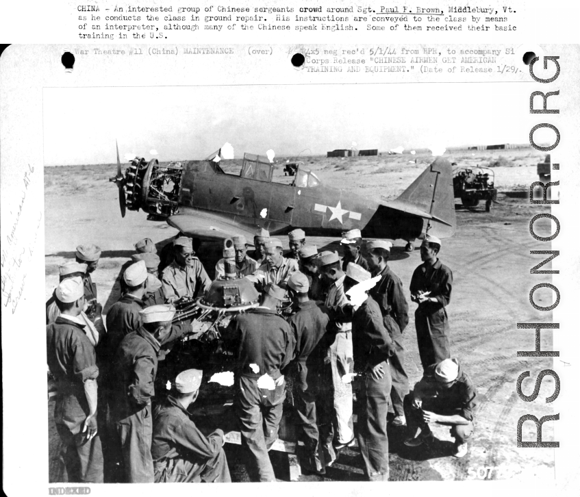 Chinese sergeants crowd around Sgt. Paul F. Brown as he conducts a class in ground repair. Instruction was via interpreter even though many of the Chinese sergeants speak English. In China during WWII.