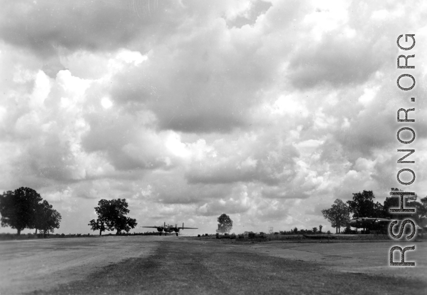 An American B-25 bomber at Yangkai, Yunnan province, in motion, while another is parked to the right. During WWII.