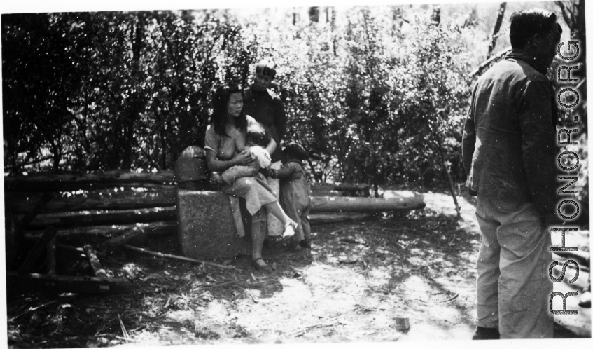 Local people in China: A woman feeds a baby. During WWII.  From the collection of Eugene T. Wozniak.