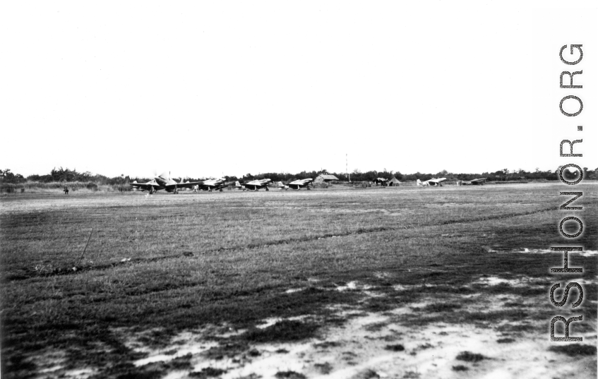 A row of P-51s in the CBI during WWII.  From the collection of Wozniak, combat photographer for the 491st Bomb Squadron, in the CBI.