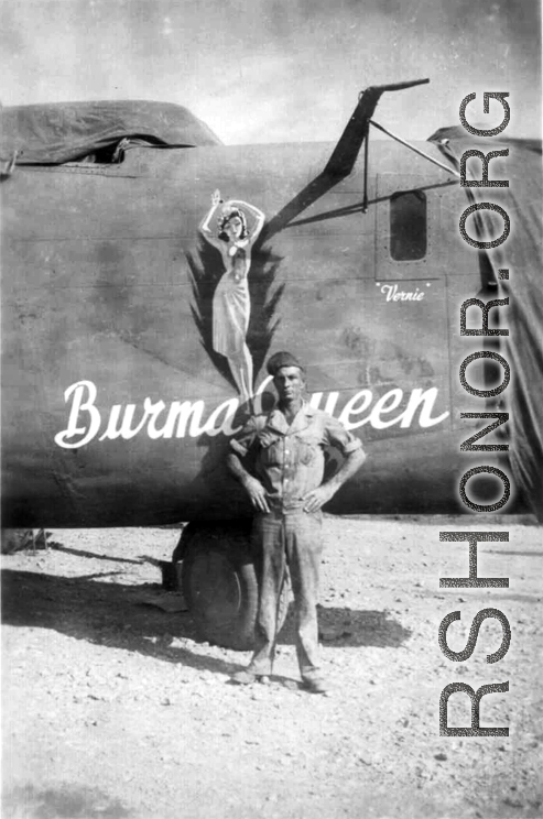 A US serviceman standing before the B-24 "Burma Queen" in the CBI.
