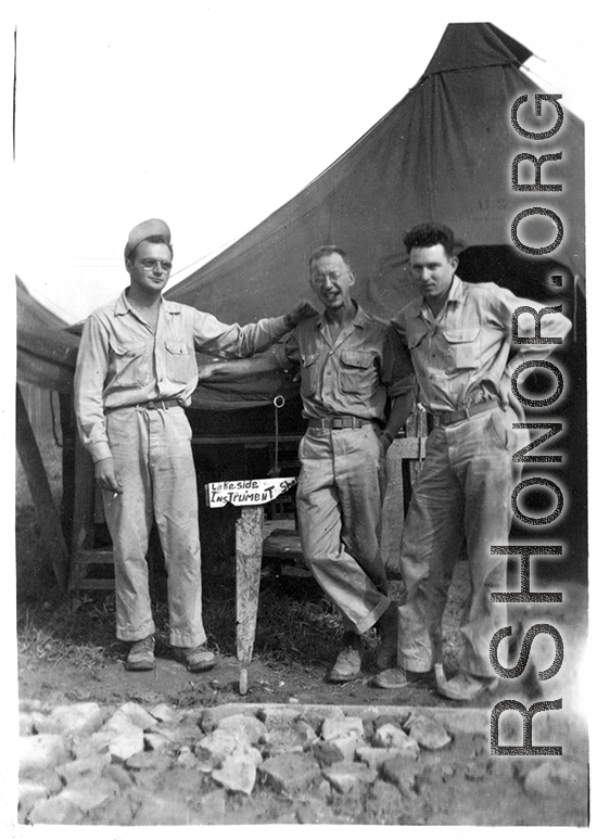 GIs in front of instrument shop tent in Liangshan, China: "Brantl, Wolfe, Hedges Taking A Break To Pose For A Picture In Front Of The Instrument Shop At Liangshan, China. Please Note The Spotless Uniforms In This Photo And All The Other Photos On This Web Site. First Class All The Way." Caption courtesy of Elmer Bukey."