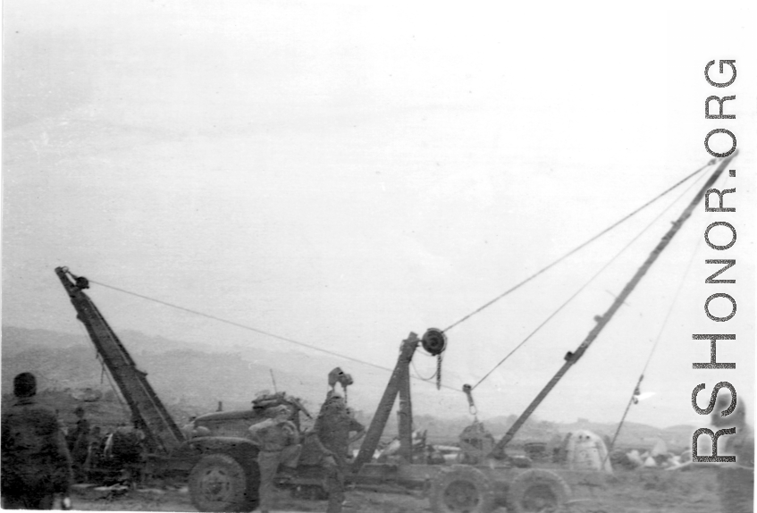 "This rig was dreamed up and built by Sgt.Miller and Sgt.Blumer. The 396th needed something that could handle all the heavy objects that had to be moved in the process of salvaging and repairing the aircraft we worked on. They built this rig on a 6x6 chasis and there wasn't much that it couldn't handle. They received a lot of praise for the job they did." Caption courtesy of Elmer Bukey.