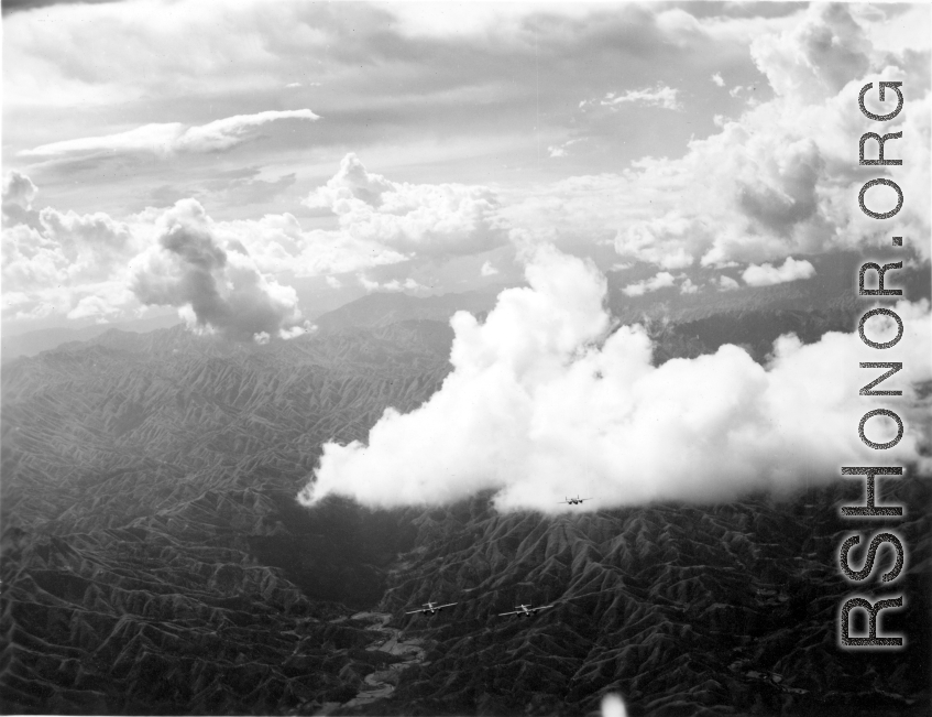 B-25 Mitchell bombers in flight over mountains in the CBI during WWII.