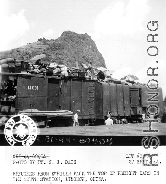 September 27, 1944  During WWII, refugees from Kweilin (Guilin) pack the top of freight cars in the south station, Liuchow, China.  Photo by Lt. N. J. Dain