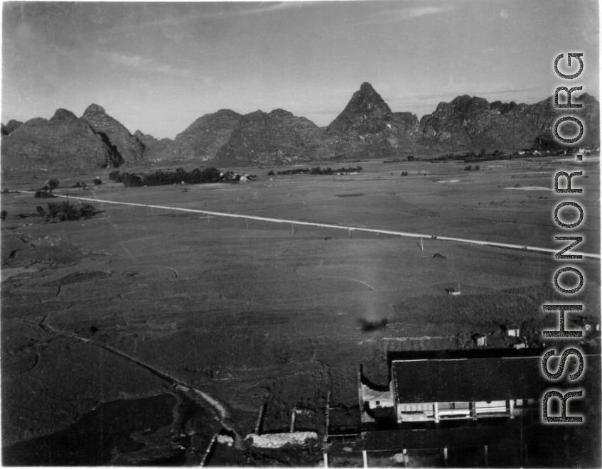 Photos taken by Robert F. Riese in or around Liuzhou city, Guangxi province, China, in 1945.  Aerial view adjacent to the American base at Liuzhou. Notice the shadow the airplane in the foreground.