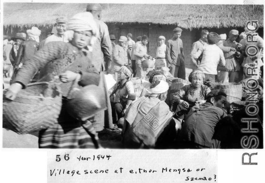 "Village scene in Mengsa or Szemao" in SW China, in 1944, during WWII. Likely market day activities.