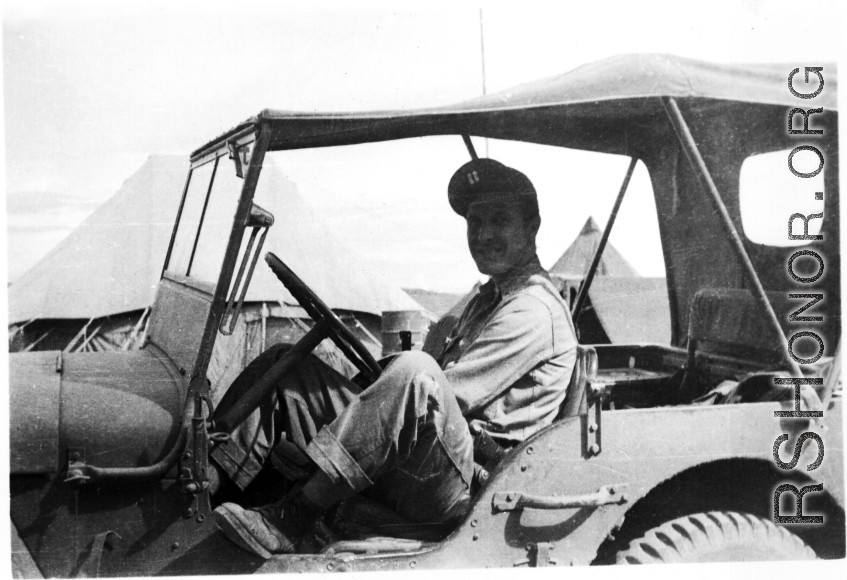 An American serviceman sits in a jeep, presumably a member of the 27th Troop Carrier Squadron, in the CBI.