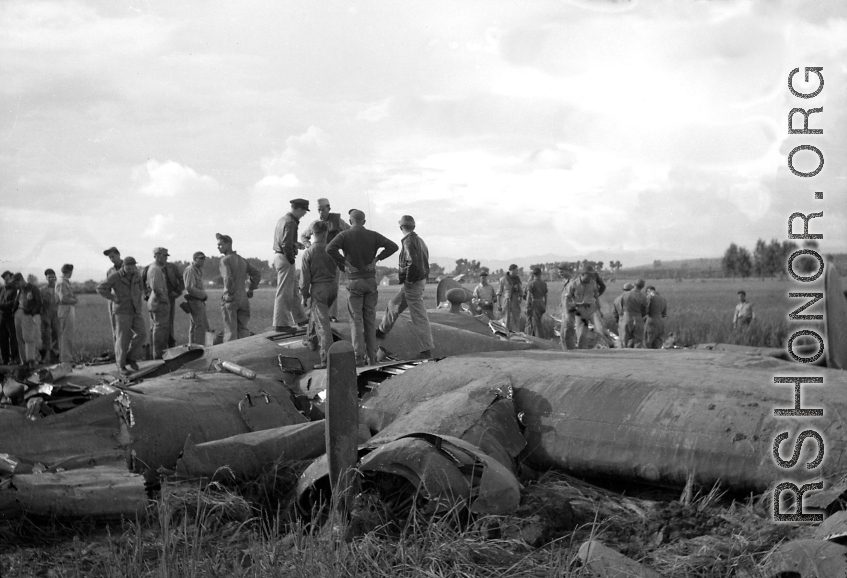 GIs inspect crashed B-24 in a grainfield in China during WWII, between 1943-1945. 
