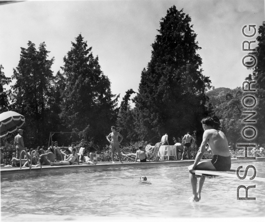 GIs do poolside R&R, during WWII, at hilltop rest house or manor house. In India? Ceylon? Note round crenelated tower in the background.