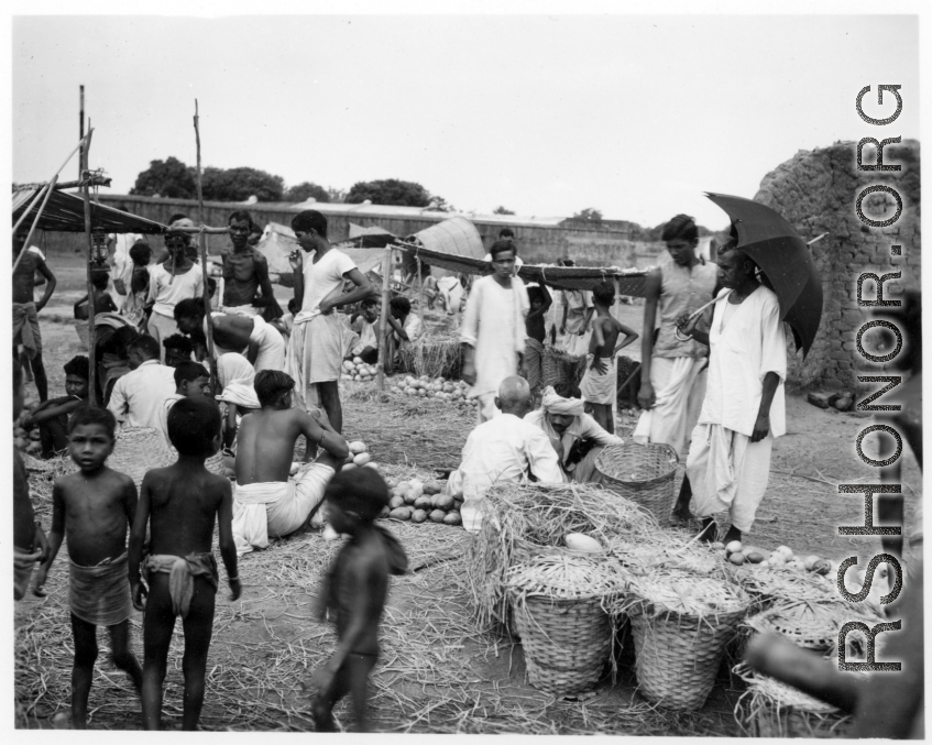 Busy market scene.  Scenes in India witnessed by American GIs during WWII. For many Americans of that era, with their limited experience traveling, the everyday sights and sounds overseas were new, intriguing, and photo worthy.