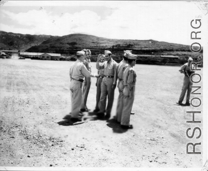 Major Gen. Charles B. Stone salutes during an award ceremony during a visit to Yangkai on the August 29, 1945. A photographer stands on the far right.  Yangkai, APO 212, during WWII.