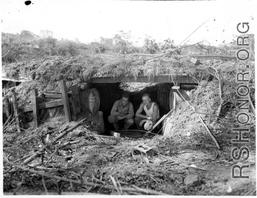Engineers of the 797th Engineer Forestry Company pose in an old bunker, either American or Japanese.  During WWII.