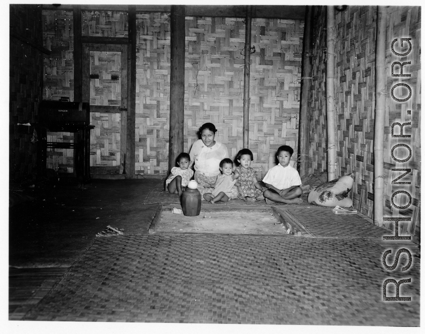 Local people in Burma near the 797th Engineer Forestry Company--A woman with children in a home in Burma.  During WWII.