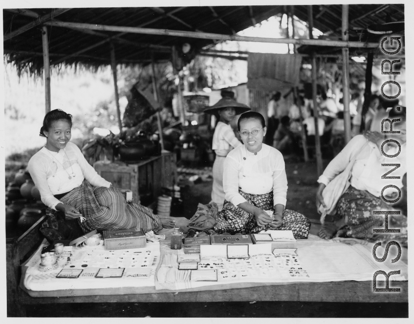 Local people in Burma near the 797th Engineer Forestry Company--ladies selling worked jewels in a market in Burma.  During WWII.