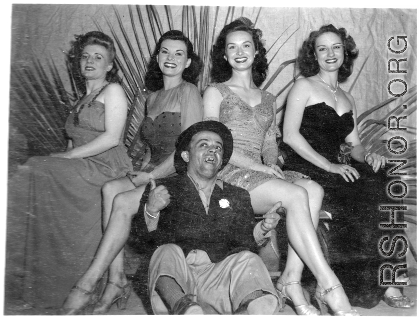 Ladies and tramp of a USO show in Gushkara, India, during WWII.