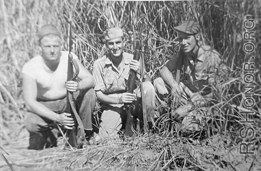 Men of 330th Troop Carrier, 9th CC, out hunting, stand in a field with carbines in the CBI during WWII.  Left to right: R. C. Werner, Milt Sobel, and K.J. Tolley.  From the collection of Arnold Wall. (Much appreciation to son D. W.)