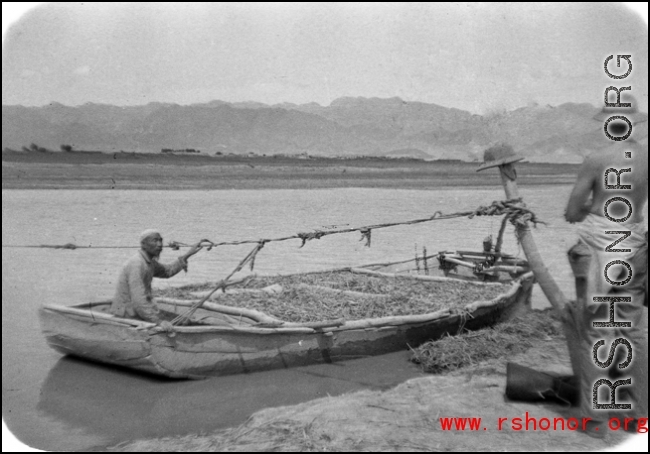 GI observes boat carrying produce on river in northern China, a Muslim man at the helm. This is most probably the Yellow River. During WWII.