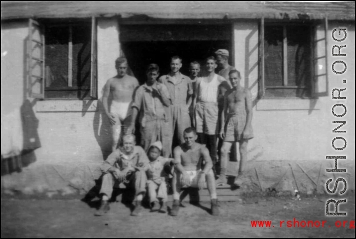 "The Adopted One--This Is A Group Of The 396th Guys Having Their Picture Taken With A Small Chinese Boy That We Adopted As A Mascot. " Caption courtesy of Elmer Bukey.