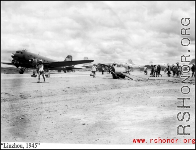 Runway with workers, hand-pulled roller, and airplanes in busy profusion, on the US base at Liuzhou, Guangxi province, China, in 1945.
