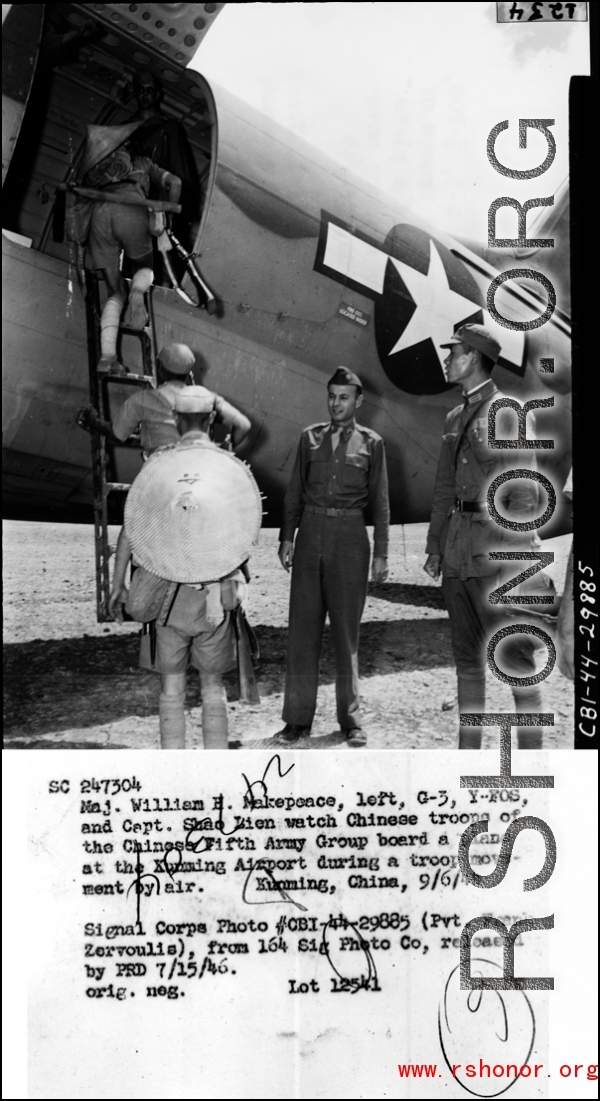 Maj. William H. Makepeace, left, G-3, Y-FOS, and Capt. Shao Lien watch Chinese troops of the Chinese Fifth Army Group board a plane at the Kunming Airport during a troopp movement by air. Kunming, China, 9/69/44