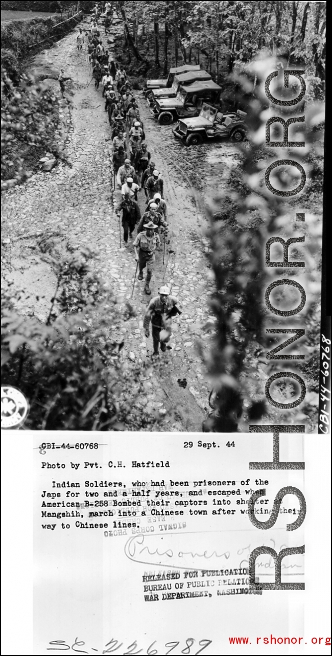 Indian Soldiers, who had been prisoners of the Japanese for two and a half years, and escaped when American B-25s bombed their captors into shelter at Mangshih (Mangshi), march into a Chinese town after working their way to Chinese lines. 29 September 1944.
