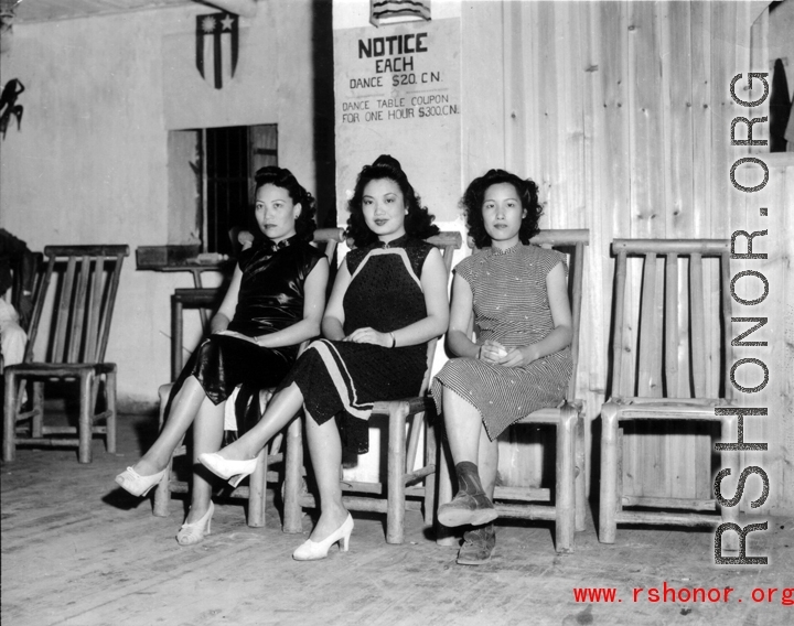 Three Chinese women wait for American servicemen to come pay for a dance at a dance hall in the CBI.