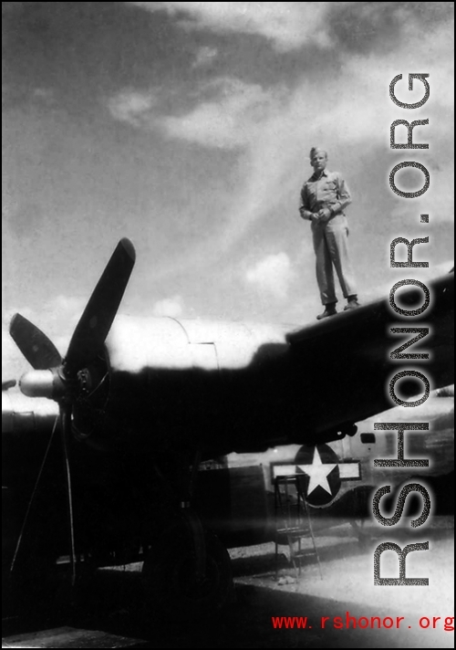 An American standing on a wing of a B-24 in the CBI.