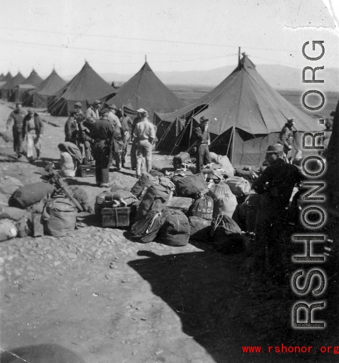GI bags piled for another move at a housing area at an American base in the CBI.