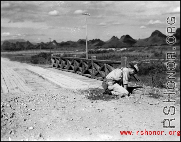 An American preparing for demolition work during the evacuation before the Japanese Ichigo advance in 1944, in Guangxi province.  Selig Seidler was a member of the 16th Combat Camera Unit in the CBI during WWII.