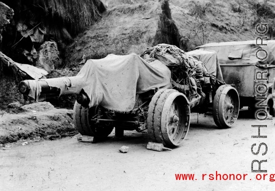 Chinese heavy gun by the side of the road in southwest China, during WWII.  Notice the rigid wheels--rubber was in short supply during wartime.