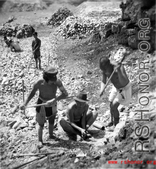 Laborers breaking stone by hand tools in southwest China, during WWII.