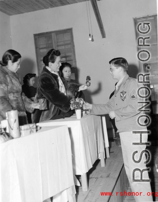An American serviceman receiving gifts from Chinese civilian representatives in the CBI during WWII.
