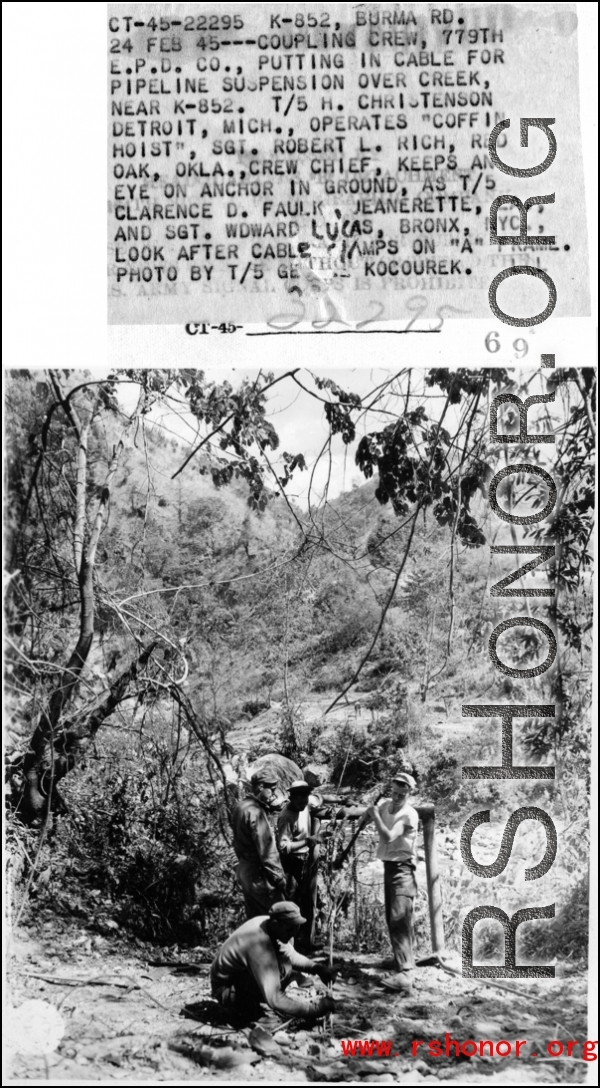 February 24, 1945--A coupling crew of the 779th Engineer Petroleum Distribution Company puts in a cable for pipeline suspension over creek near K-852. T/5 H. Christenson operates "coffin hoist," Sgt. Robert L. Rich keeps an eye on anchor in ground, as T/5 Clarence D. Faulk and Sgt. Edward Lucas look after cable clamps on "A" frame.  Photo by T/5 George Kocourek.