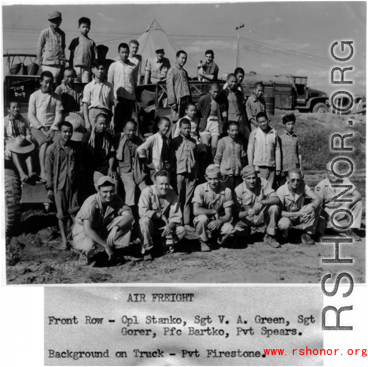 Members of air freight crew, both GIS and local people, in China during WWII.   Front row: Cpl. Stanko, Sgt. V. A. Green, Sgt. Gorer, Pfc. Bartko, Pvt. Spears.  Background on truck: Pvt. Firestone.  Official U.S. Gov image.
