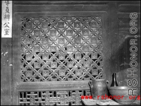 A carved wooden door screen in China. During WWII.  From the collection of Frank Bates.