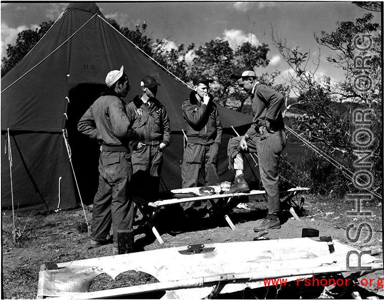 GIs talk and smoke in front of a tent at Qingshuihai lake.