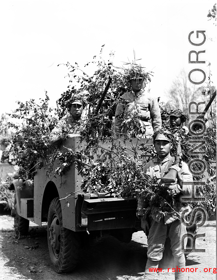 Chinese soldiers with equipment ready and covered in camouflage during exercises in southern China, in Yunnan province. Despite the appearance of being on their way to battle, these men are more likely in fact prepared for a demonstration or honor parade.