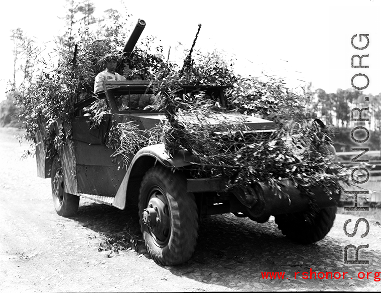 Chinese soldiers with equipment ready and covered in camouflage during exercises in southern China, in Yunnan province. Despite the appearance of being on their way to battle, these men are more likely in fact prepared for a demonstration or honor parade.