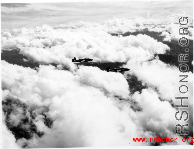 B-25 Mitchell bombers in flight in the CBI, in the area of southern China, Indochina, or Burma.