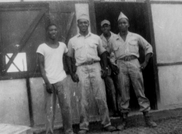 African-American servicemen stand outside the door of an "ORDERLY ROOM" in the CBI during WWII.