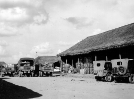 Parked jeeps and transport vehicles, Burma or SW China.