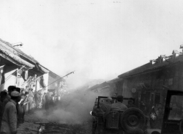 American jeeps run gauntlet of fireworks in Chinese town.