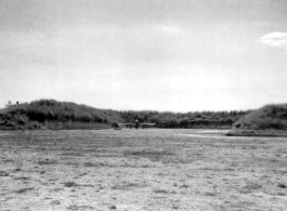 A P-51 fighter in a revetment somewhere in China.  Image from U. S. Government official sources. 