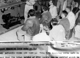 T/Sgt. Murphy D. Shell explains the intricacies of carburetor operation. with a model of P-51 systems set up behind him, to pilots and mechanics. In China.